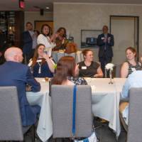 people clap, sit, and listen